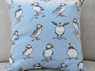 Image of Atlantic Puffins cushion cover in pale blue colourway